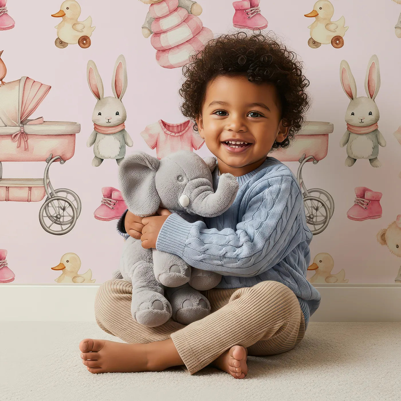 Lovely child standing in front of Whimsy Tots Tiny Tots Toy Parade Wallpaper in Blush Pink with rabbit, bird, duck, bear, stroller, boot, toy, dress in design.