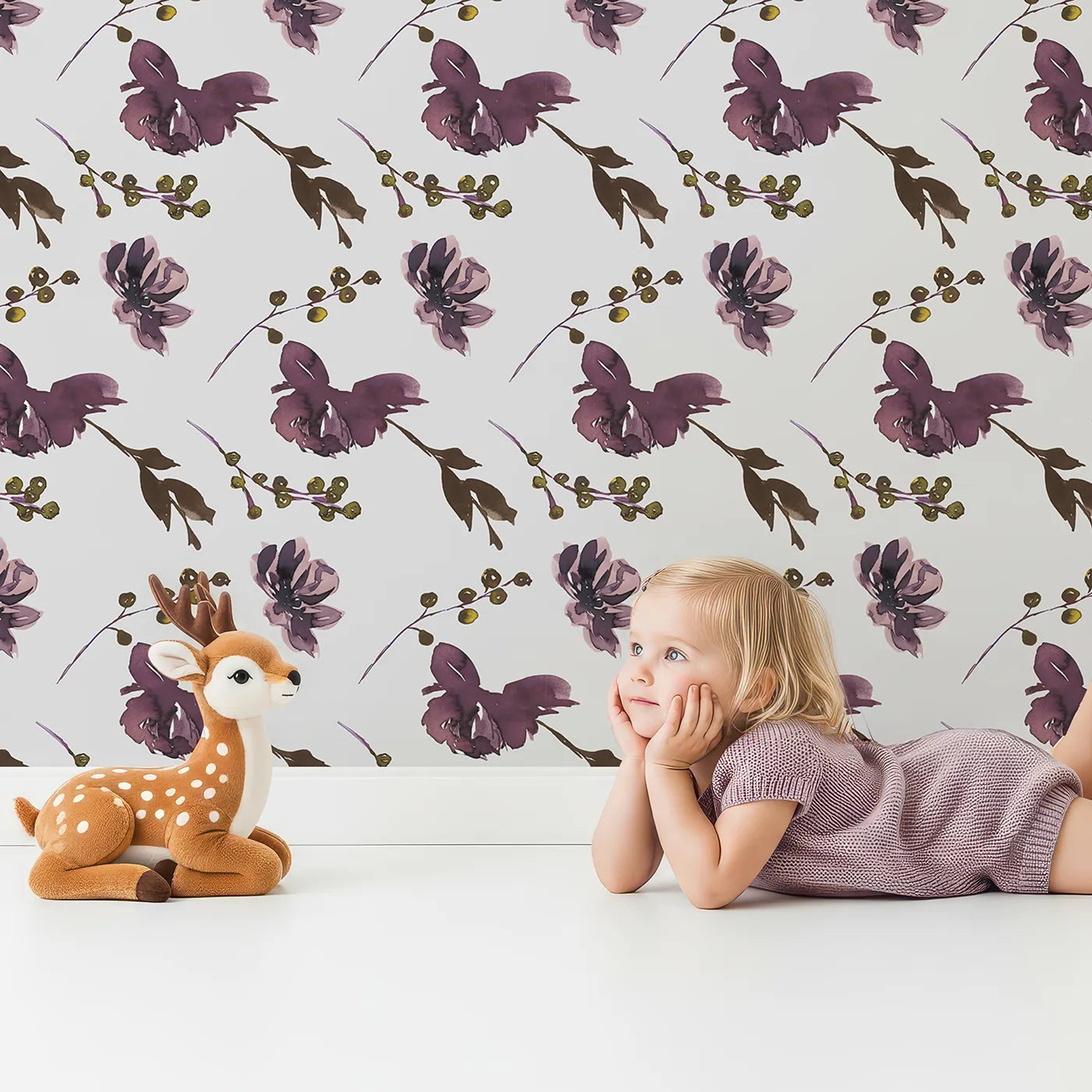 Lovely child standing in front of Whimsy Tots Shadow Garden Bloom Wallpaper with flower, petal, berry, leaf in design.