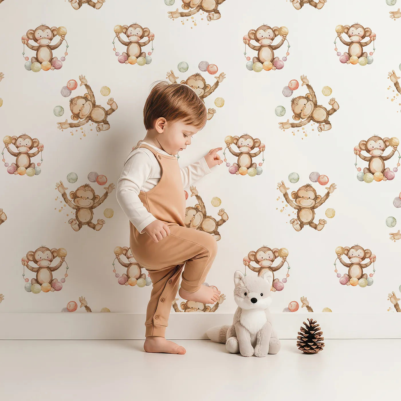 Lovely child standing in front of Whimsy Tots Monkey Juggle Parade Wallpaper with monkey, ball, confetti in design.