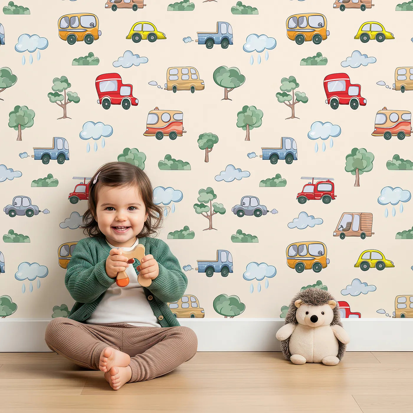 Lovely child standing in front of Whimsy Tots Bumper Buddies Forest Drive Wallpaper in Cream with car, tree, cloud, raindrop, bus in design.
