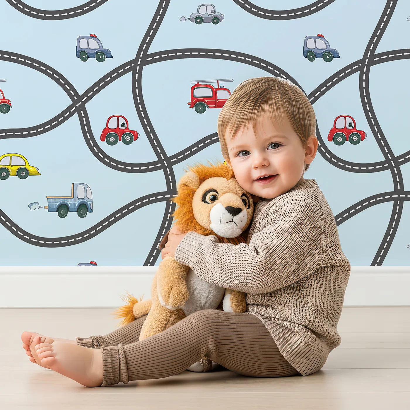 Lovely child standing in front of Whimsy Tots Bumper Buddies Road Maze Wallpaper in Sky Blue with car, road, truck, taxi in design.