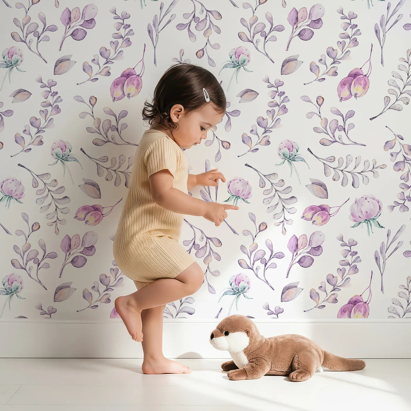 Lovely child standing in front of Whimsy Tots Lavender Breeze Wallpaper IV with flower, petal, leaf, bud in design.