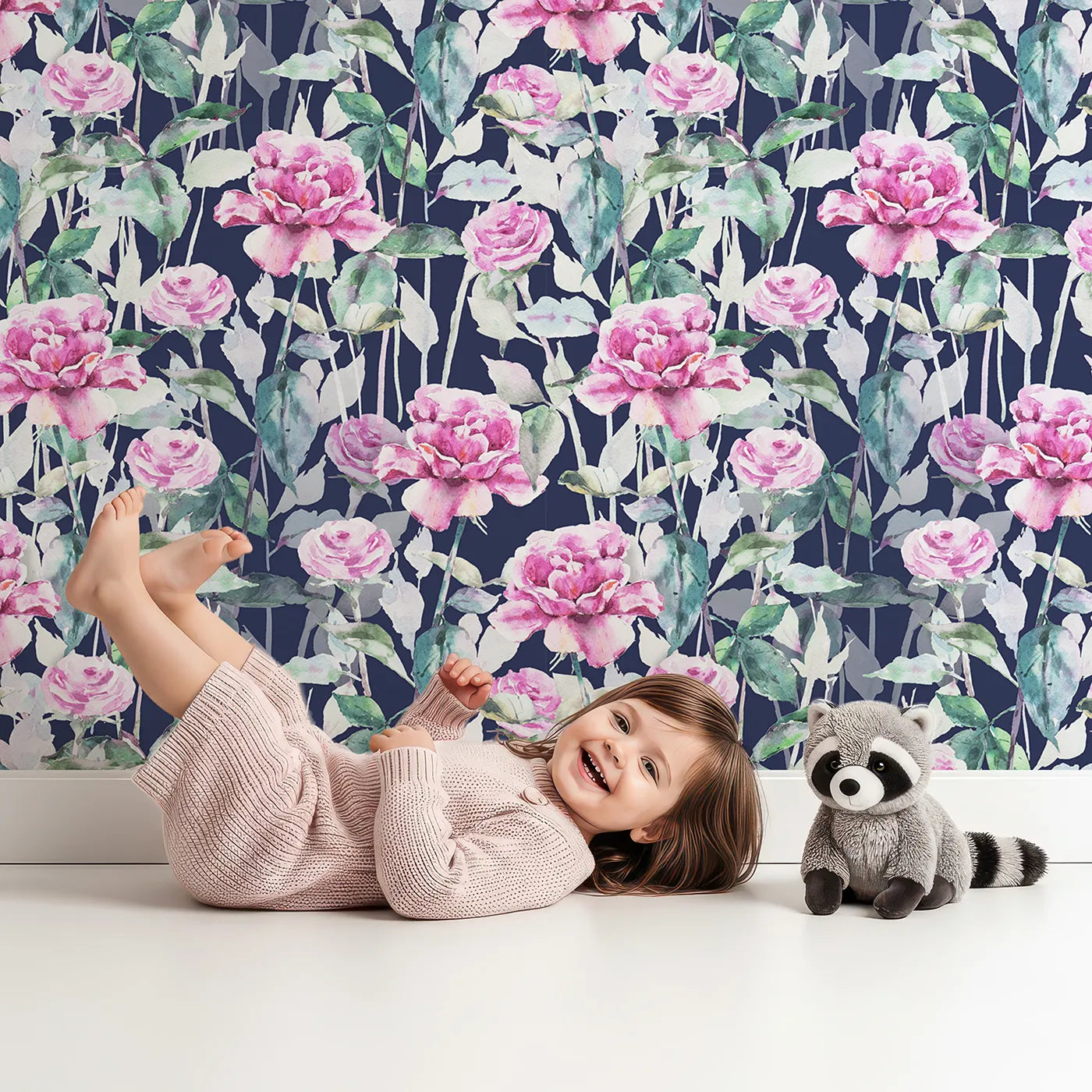Lovely child standing in front of Whimsy Tots Rosy Garden Stroll Wallpaper in Midnight with rose, flower, stem, leaf in design.