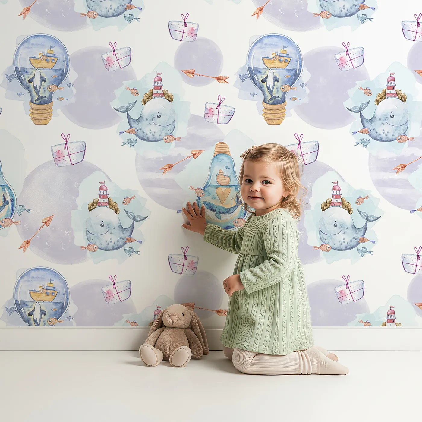 Lovely child standing in front of Whimsy Tots Ocean Gifts and Lighthouse Wishes Wallpaper with whale, gift, fish, bottle, arrow, lighthouse in design.