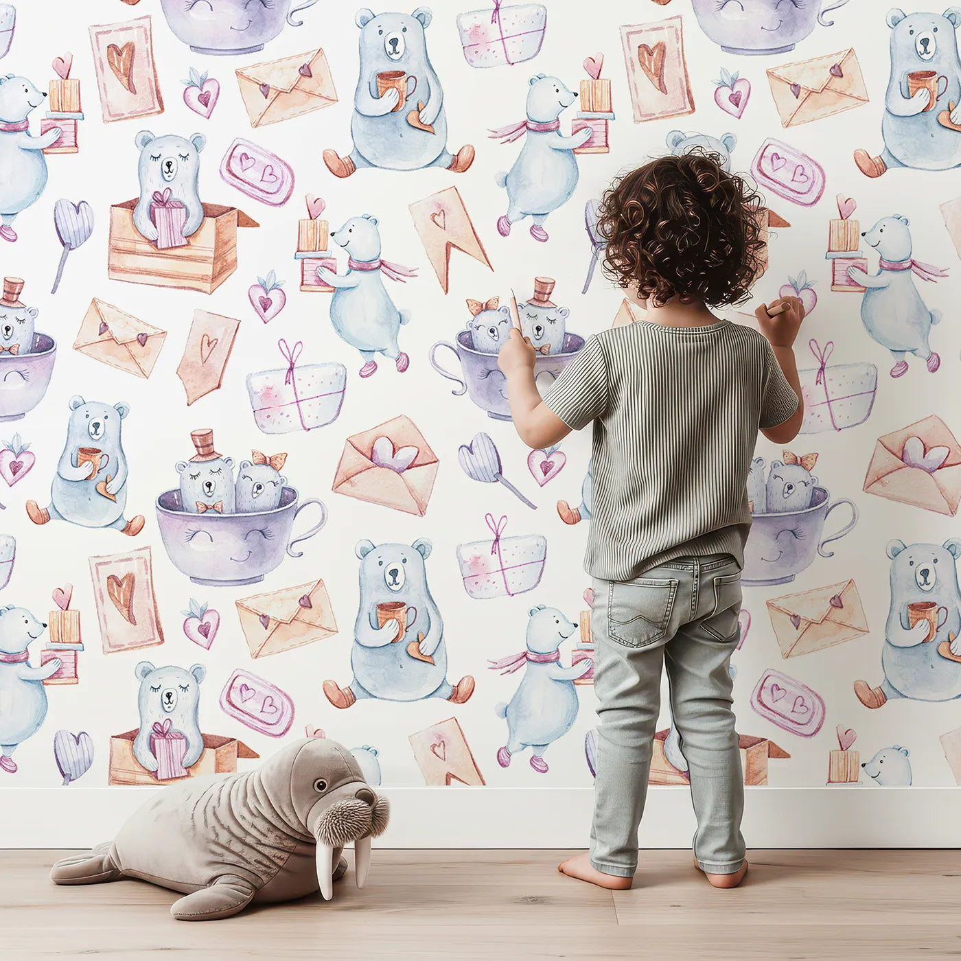 Lovely child standing in front of Whimsy Tots Bear Hugs and Love Letters Wallpaper with bear, letter, cup, heart, gift, envelope in design.