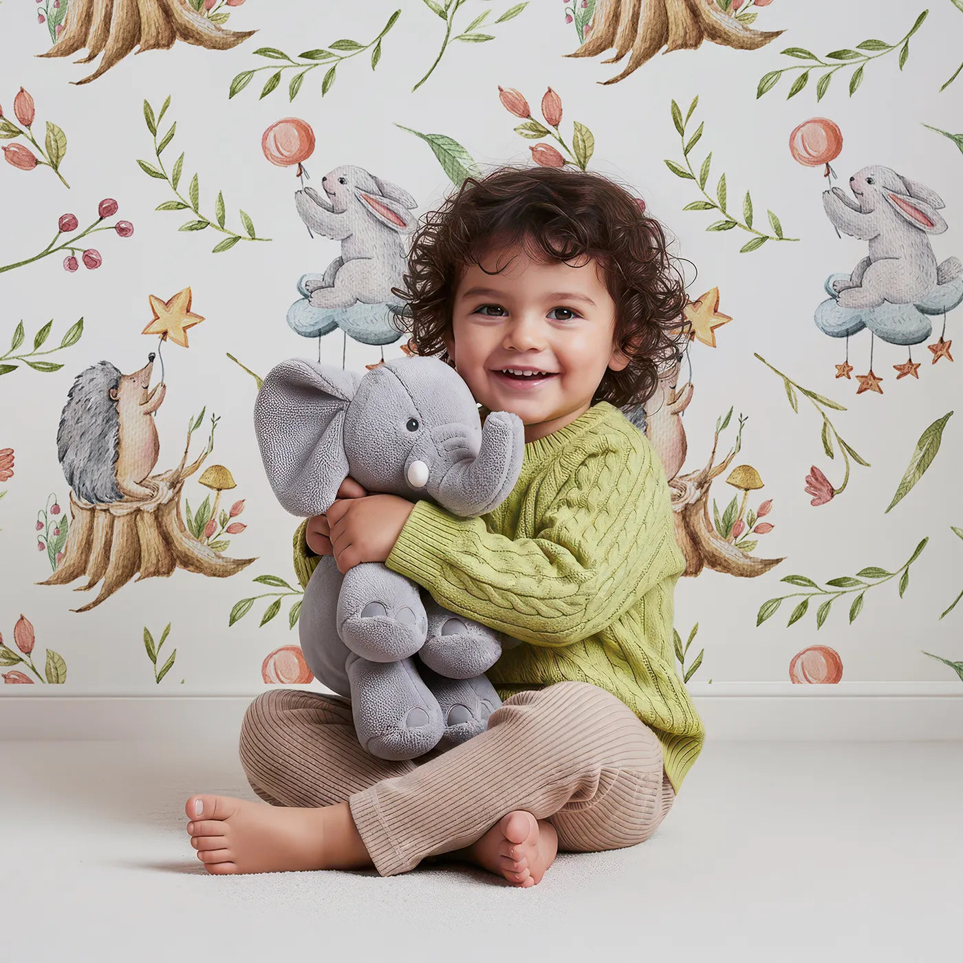 Lovely child standing in front of Whimsy Tots Starlight Forest Friends Wallpaper in White with rabbit, hedgehog, star, flower, leaf in design.