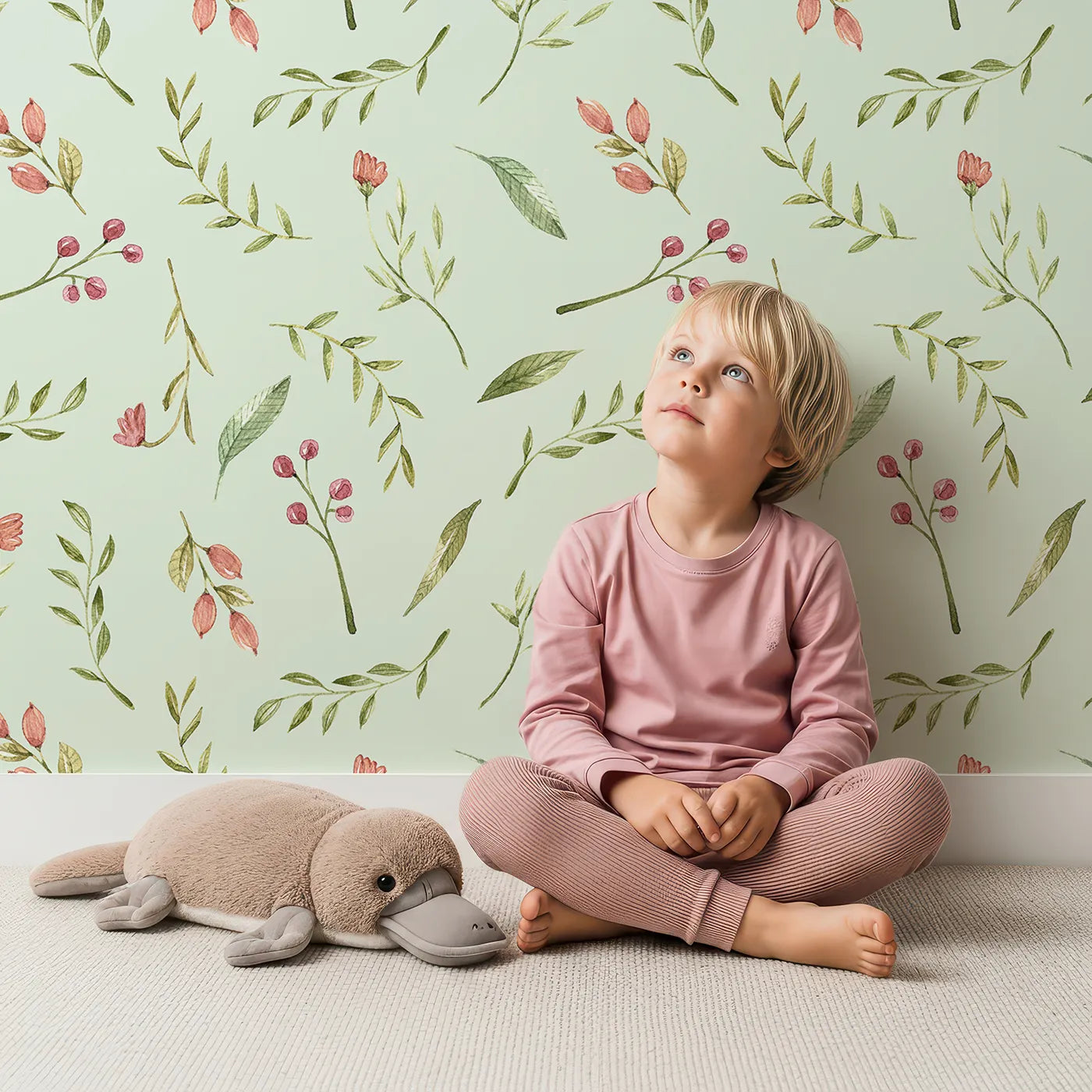 Lovely child standing in front of Whimsy Tots Blossom Meadow Breeze Wallpaper in Mint Green with flower, leaf, vine, berry in design.