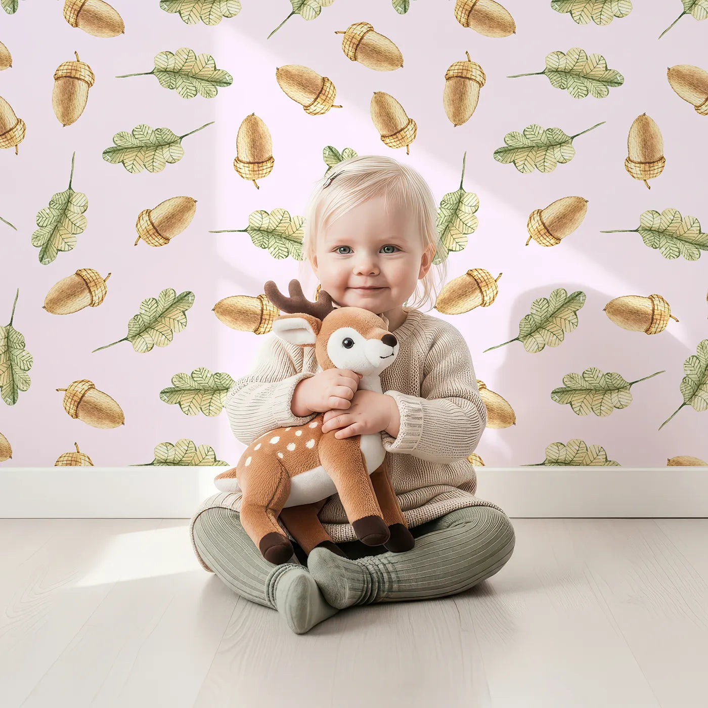 Lovely child standing in front of Whimsy Tots Acorn Meadow Whimsy Wallpaper in Blush Pink with acorn, oak leaf, leaf in design.