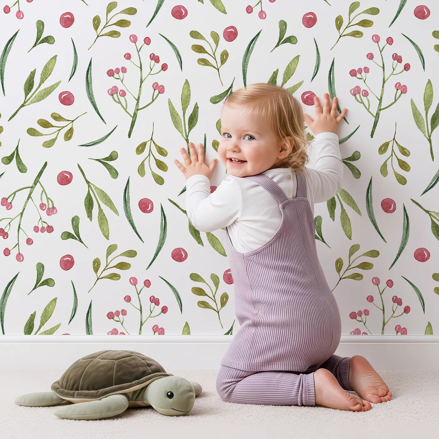 Lovely child standing in front of Whimsy Tots Berry Leaf Doodle Wallpaper in White with berry, leaf, branch, dot in design.