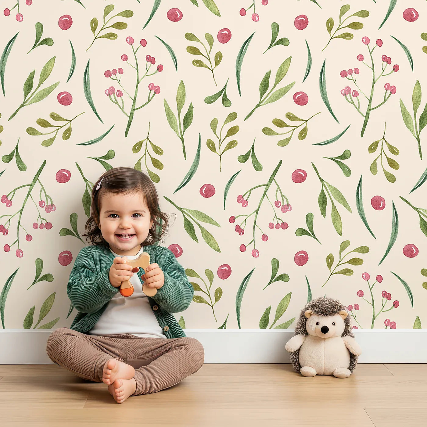 Lovely child standing in front of Whimsy Tots Berry Leaf Doodle Wallpaper in Cream with berry, leaf, branch, dot in design.