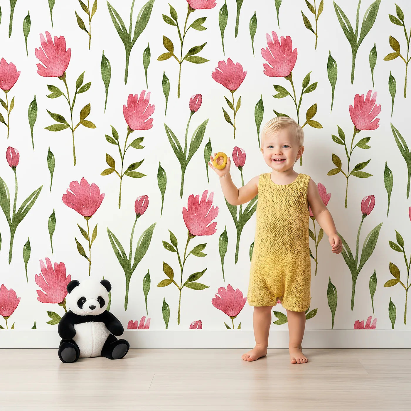 Lovely child standing in front of Whimsy Tots Tulip Meadow Blooms Wallpaper in White with tulip, flower, leaf, stem in design.
