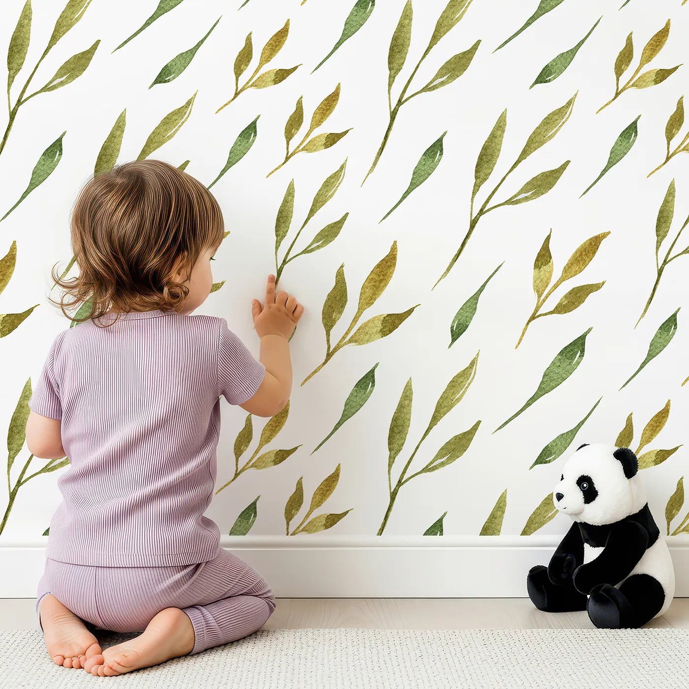 Lovely child standing in front of Whimsy Tots Wandering Willow Sprigs Wallpaper in White with leaf, sprig, branch in design.