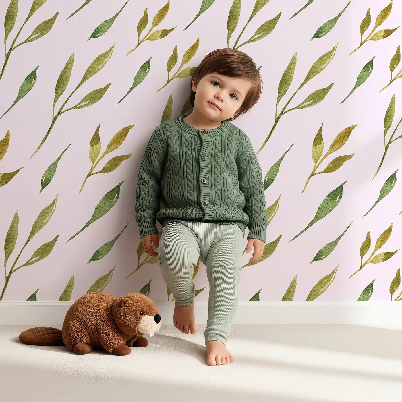 Lovely child standing in front of Whimsy Tots Wandering Willow Sprigs Wallpaper in Blush Pink with leaf, sprig, branch in design.