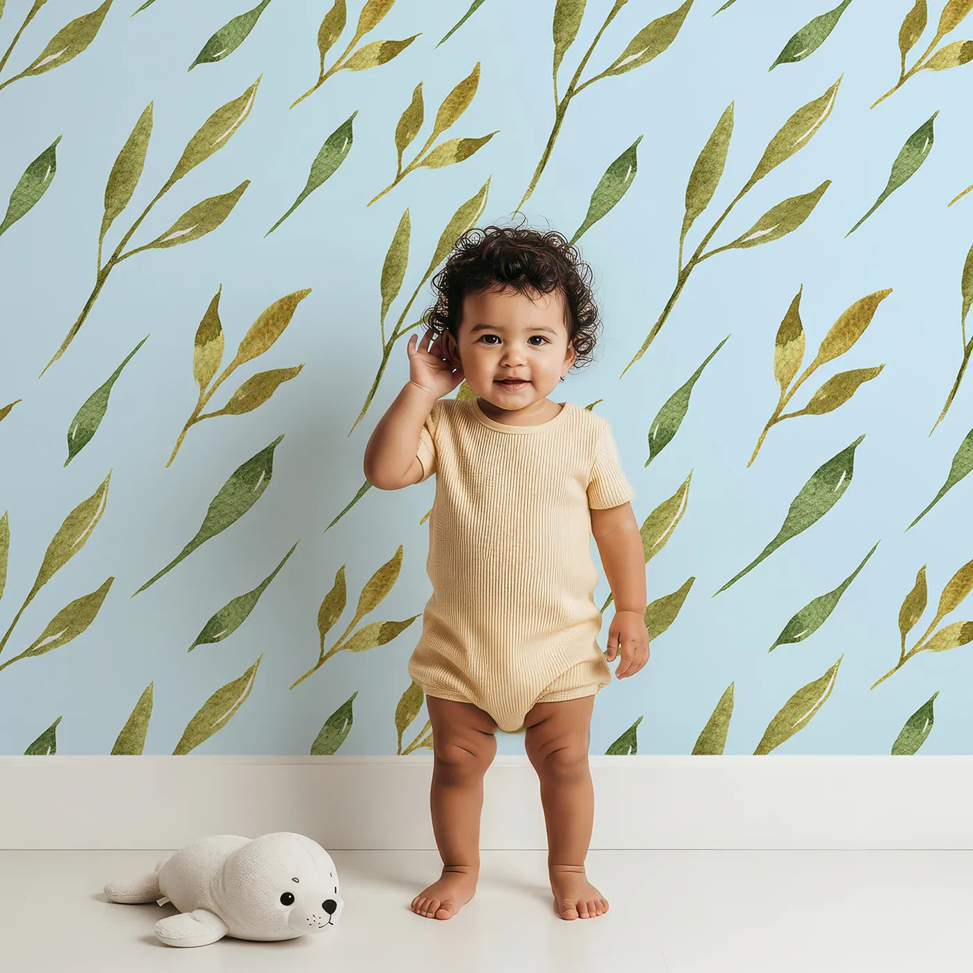Lovely child standing in front of Whimsy Tots Wandering Willow Sprigs Wallpaper in Sky with leaf, sprig, branch in design.