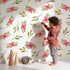 Lovely child standing in front of Whimsy Tots Whimsy Bloom Sprays Wallpaper in White with flower, leaf, bloom, spray in design. Lovely child standing in front of Whimsy Tots Whimsy Bloom Sprays Wallpaper in White with flower, leaf, bloom, spray in design.