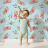 Lovely child standing in front of Whimsy Tots Whimsy Bloom Sprays Wallpaper in Sky Blue with flower, leaf, bloom, spray in design. Lovely child standing in front of Whimsy Tots Whimsy Bloom Sprays Wallpaper in Sky Blue with flower, leaf, bloom, spray in design.