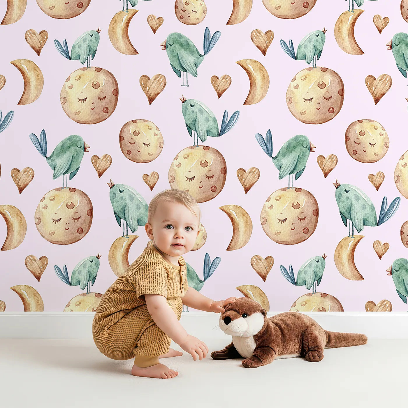 Lovely child standing in front of Whimsy Tots Moon Melody Wallpaper in Blush Pink with bird, moon, heart, star in design.