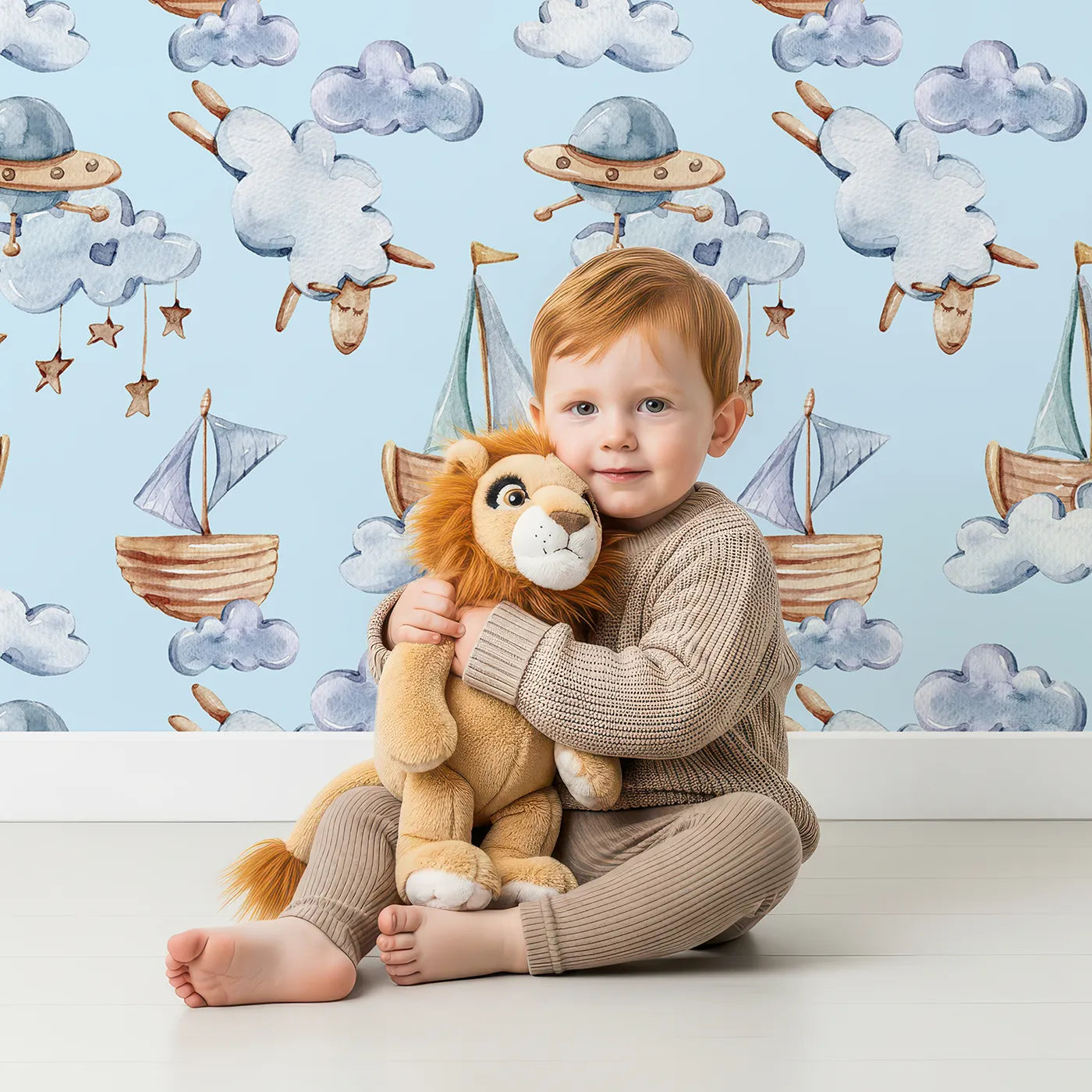 Lovely child standing in front of Whimsy Tots Cloud Sailor Dreams Wallpaper in Blue with ship, cloud, sheep, star, sail in design.