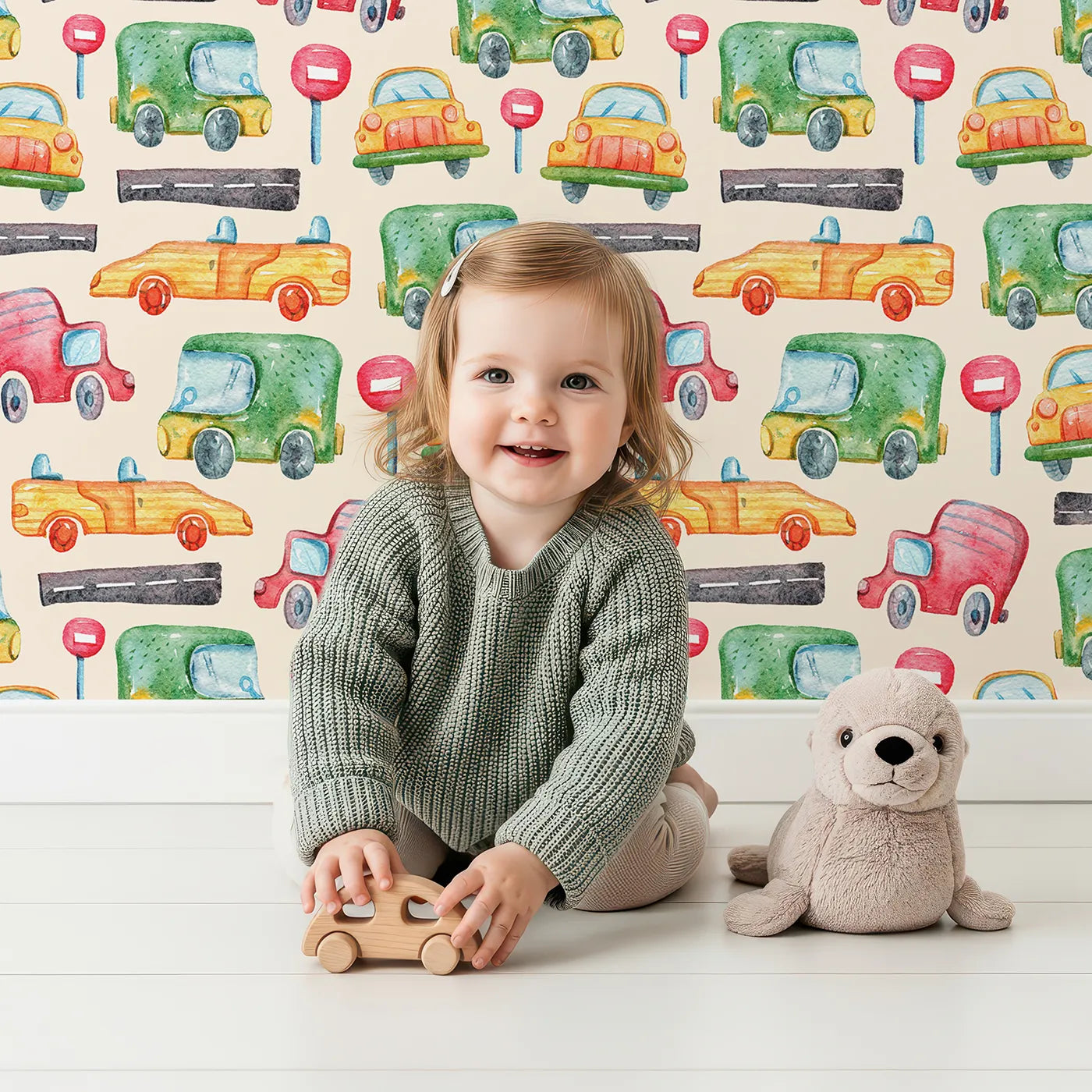 Lovely child standing in front of Whimsy Tots Little Car Parade Wallpaper in Cream with car, sign, road in design.