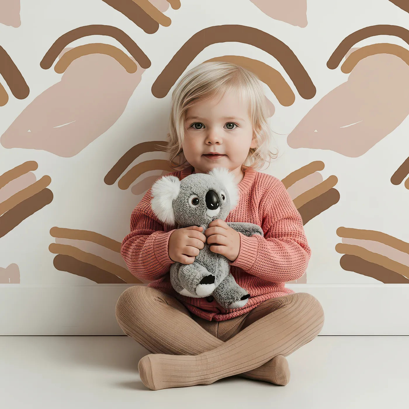 Lovely child standing in front of Whimsy Tots Sunset Rainbow Loops Wallpaper with rainbow, arch, abstract in design.