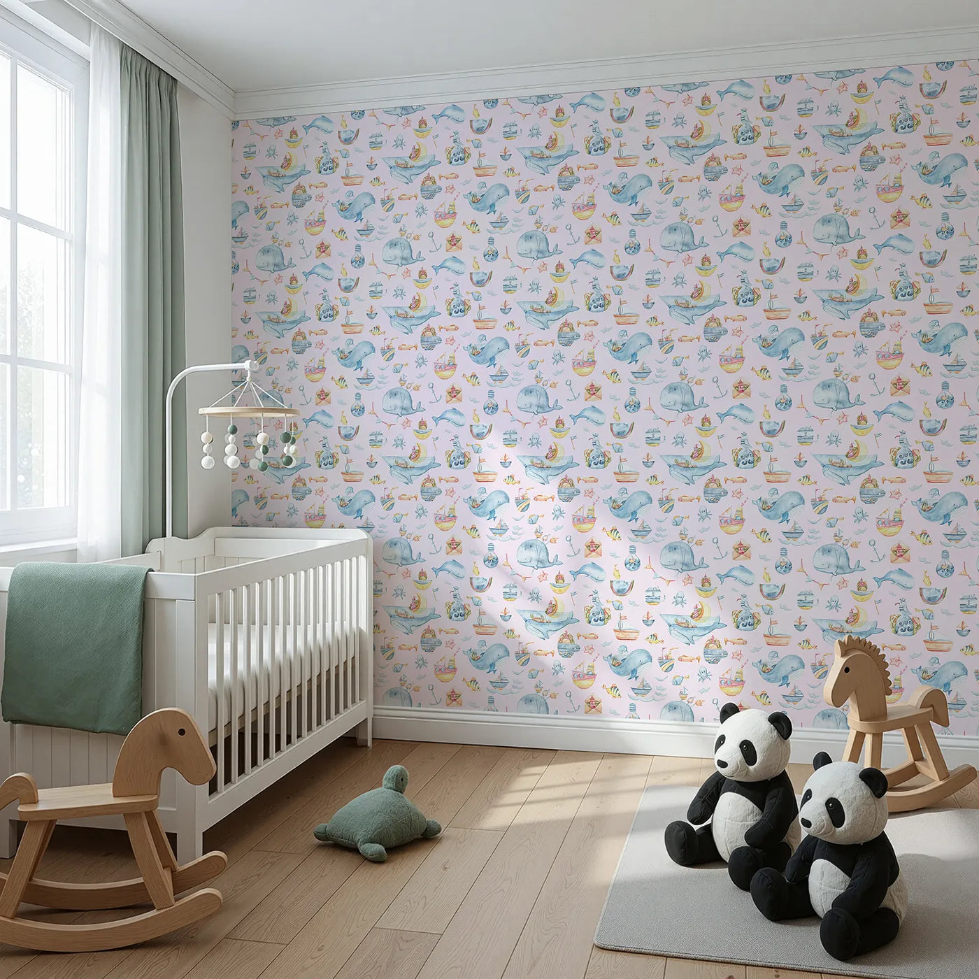 Angled view of Whimsy Tots' Whale Mail Wallpaper in Pink (W3313B).Whimsical whales swim through pink skies with tiny ocean treasures in tow.