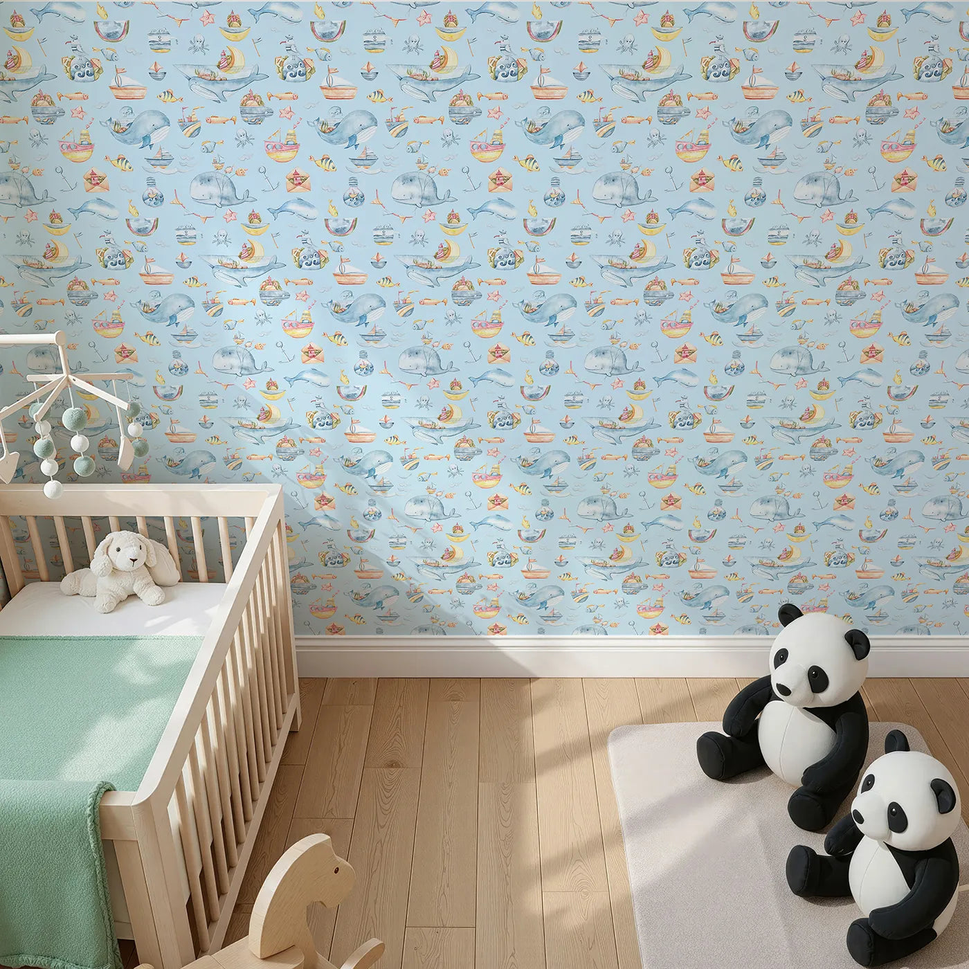 Top-Down view of Whimsy Tots' Whale Mail Wallpaper in Sky Blue (W3313E).Cheerful whales swim across blue skies with mail, mugs, and marine treasures.