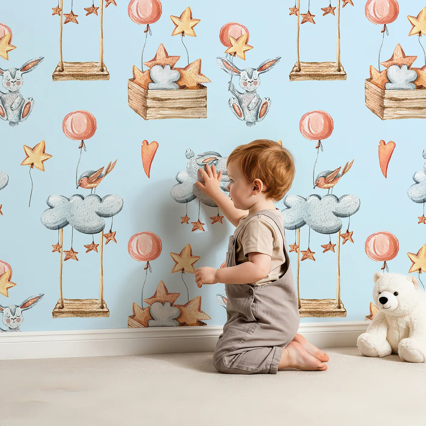 Lovely child standing in front of Whimsy Tots Dreamland Friends Wallpaper in Blue with bird, bunny, cloud, balloon, star in design.