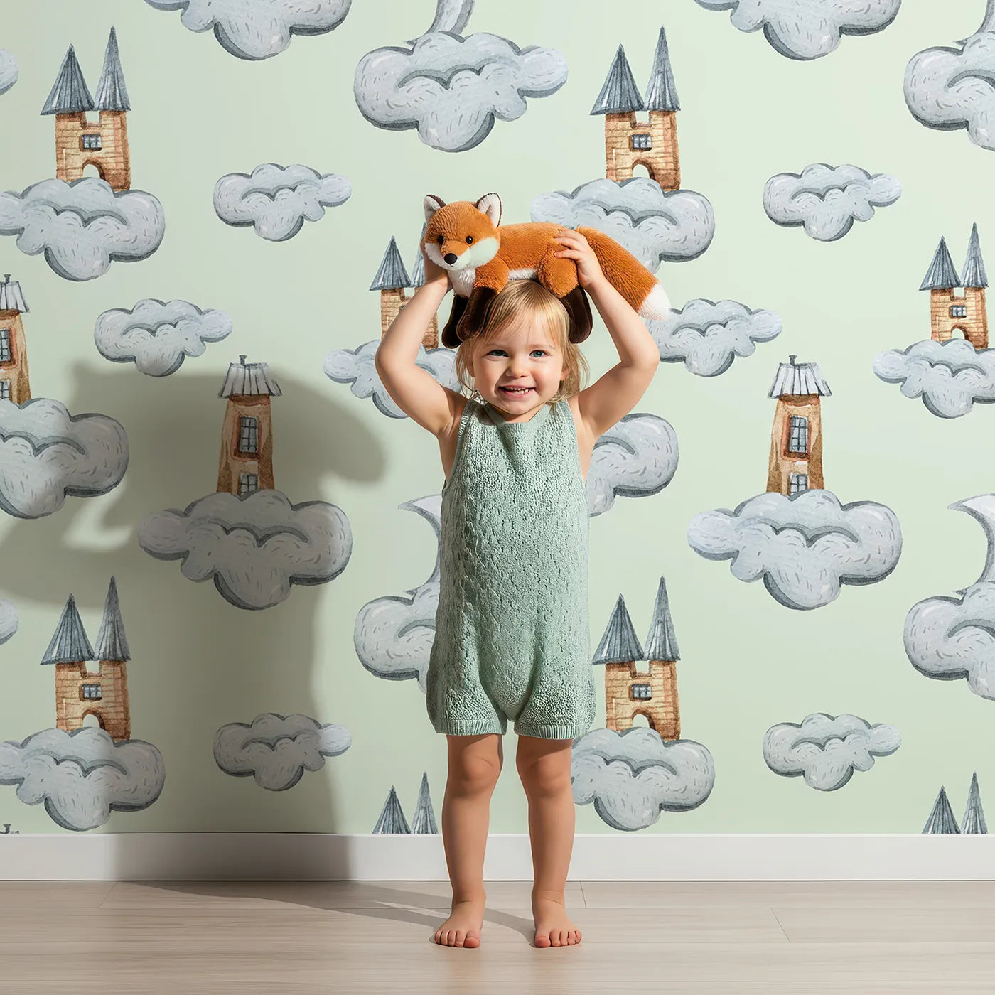 Lovely child standing in front of Whimsy Tots Castle Cloud Drift Wallpaper in Mint Green with castle, cloud, moon in design.