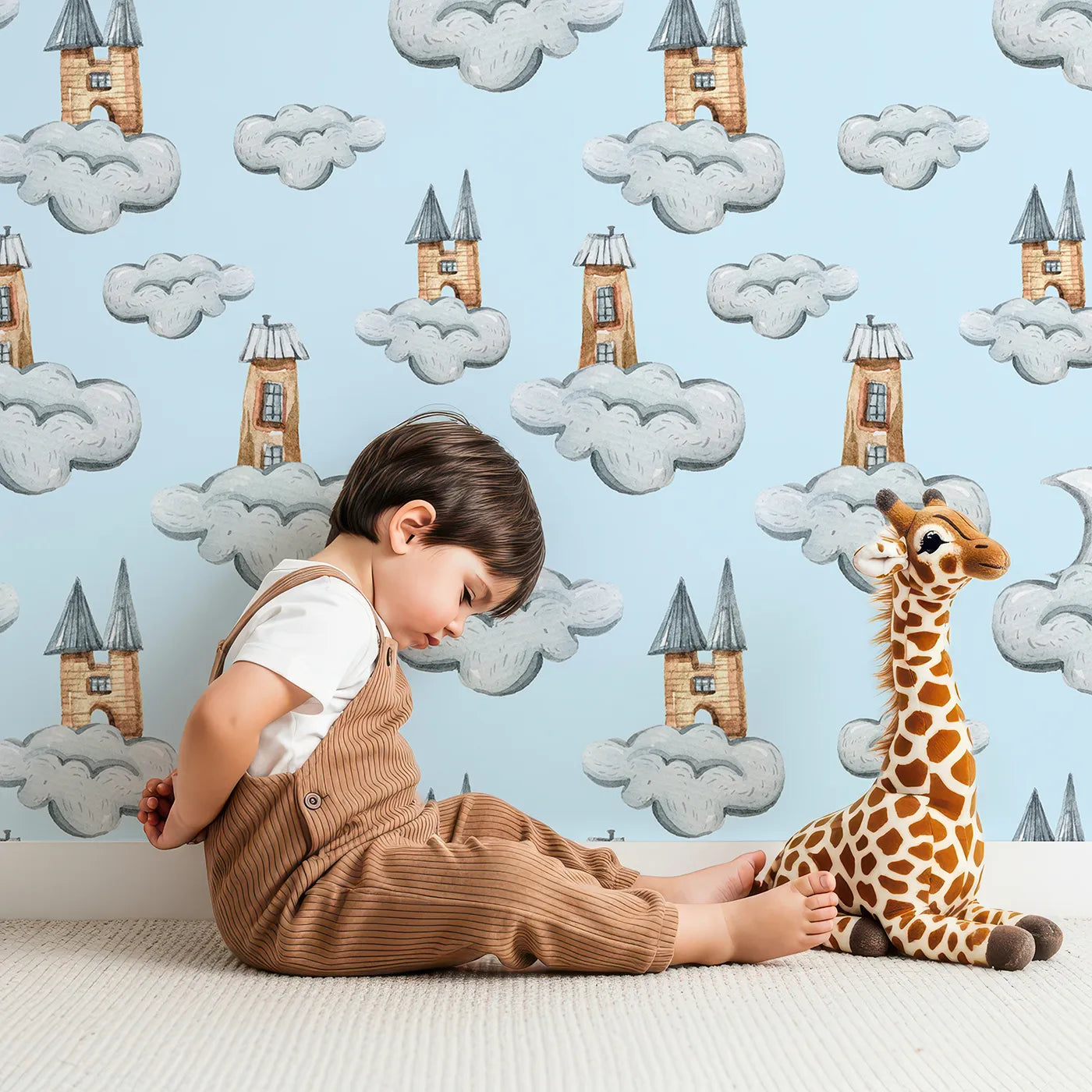 Lovely child standing in front of Whimsy Tots Castle Cloud Drift Wallpaper in Blue with castle, cloud, moon in design.