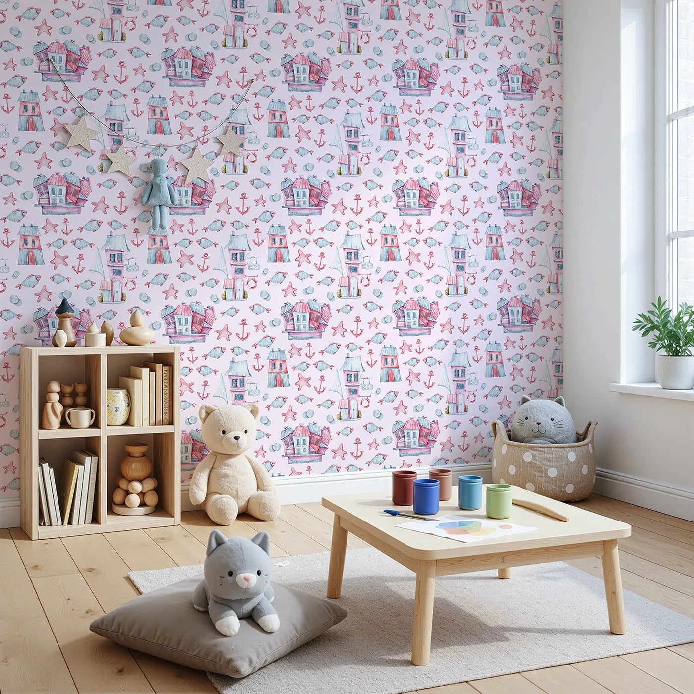 Angled view of Whimsy Tots' Seaside Village Parade Wallpaper in Pink (W3320B).Charming houses and cheerful sea creatures play across a pink seaside dream.