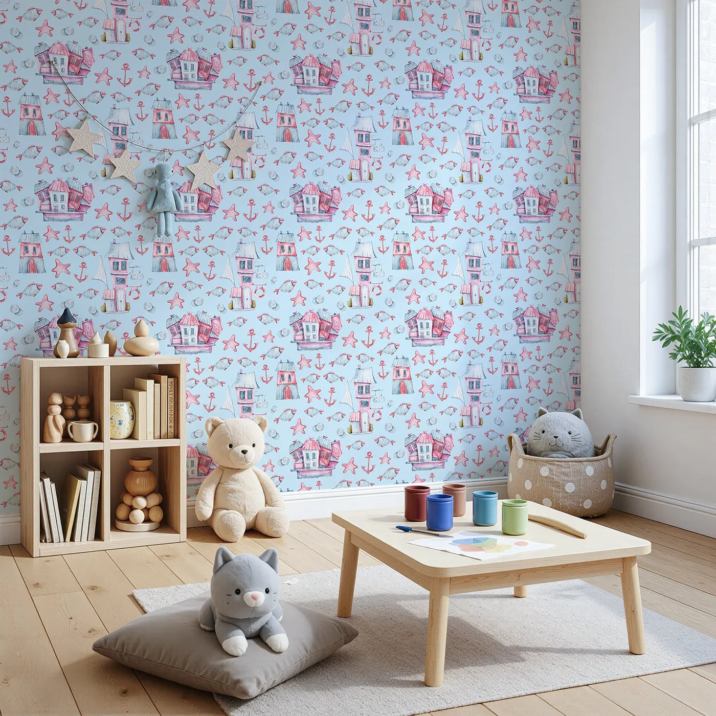 Angled view of Whimsy Tots' Seaside Village Parade Wallpaper in Blue (W3320E).Seaside homes and playful fish drift through a cheerful ocean sky.