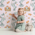 Lovely child standing in front of Whimsy Tots Star Catcher Bunnies Wallpaper in Pink with rabbit, star, cloud, net in design. Lovely child standing in front of Whimsy Tots Star Catcher Bunnies Wallpaper in Pink with rabbit, star, cloud, net in design.