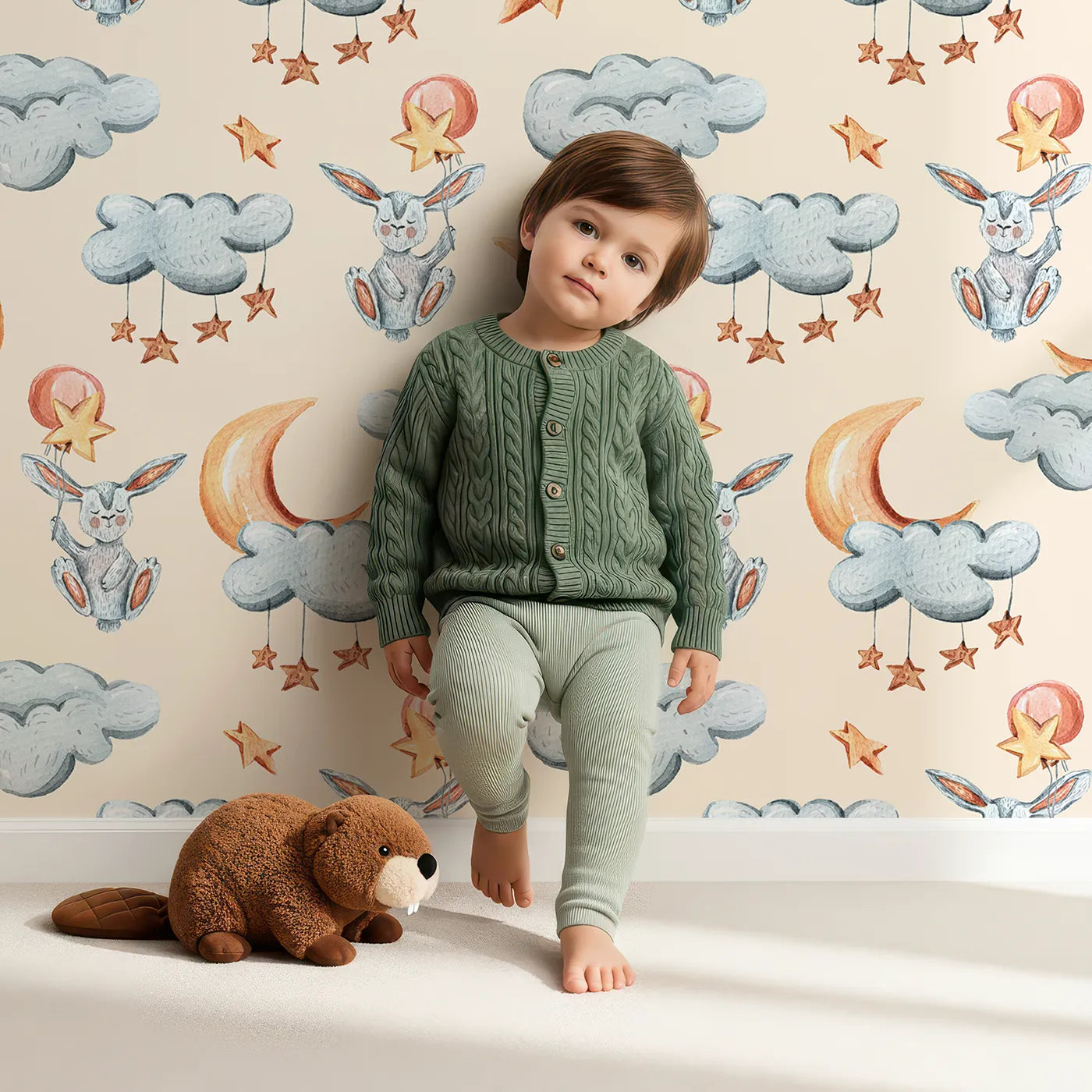 Lovely child standing in front of Whimsy Tots Starry Bunny Balloons Wallpaper in Cream with bunny, balloon, star, cloud, moon in design.