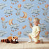Lovely child standing in front of Whimsy Tots Starry Bunny Balloons Wallpaper in Sky with bunny, balloon, star, cloud, moon in design. Lovely child standing in front of Whimsy Tots Starry Bunny Balloons Wallpaper in Sky with bunny, balloon, star, cloud, moon in design.