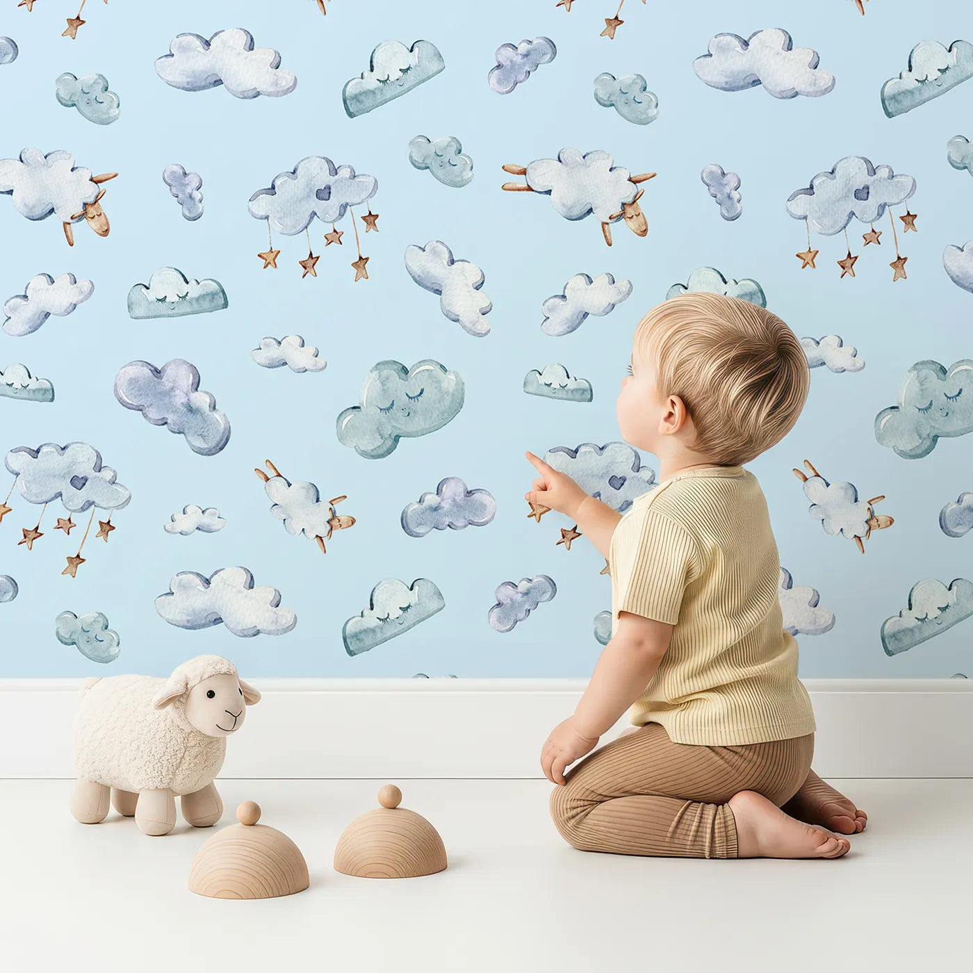 Lovely child standing in front of Whimsy Tots Counting Cloud Sheep Wallpaper in Sky with cloud, sheep, star, mobile in design.