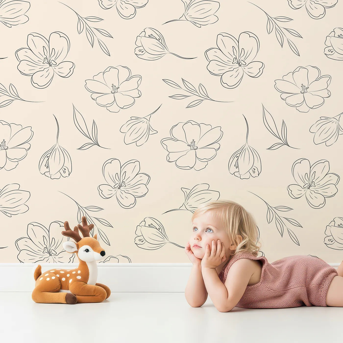 Lovely child standing in front of Whimsy Tots Line Art Bloom Wallpaper in Cream with flower, blossom, lineart, leaf in design.