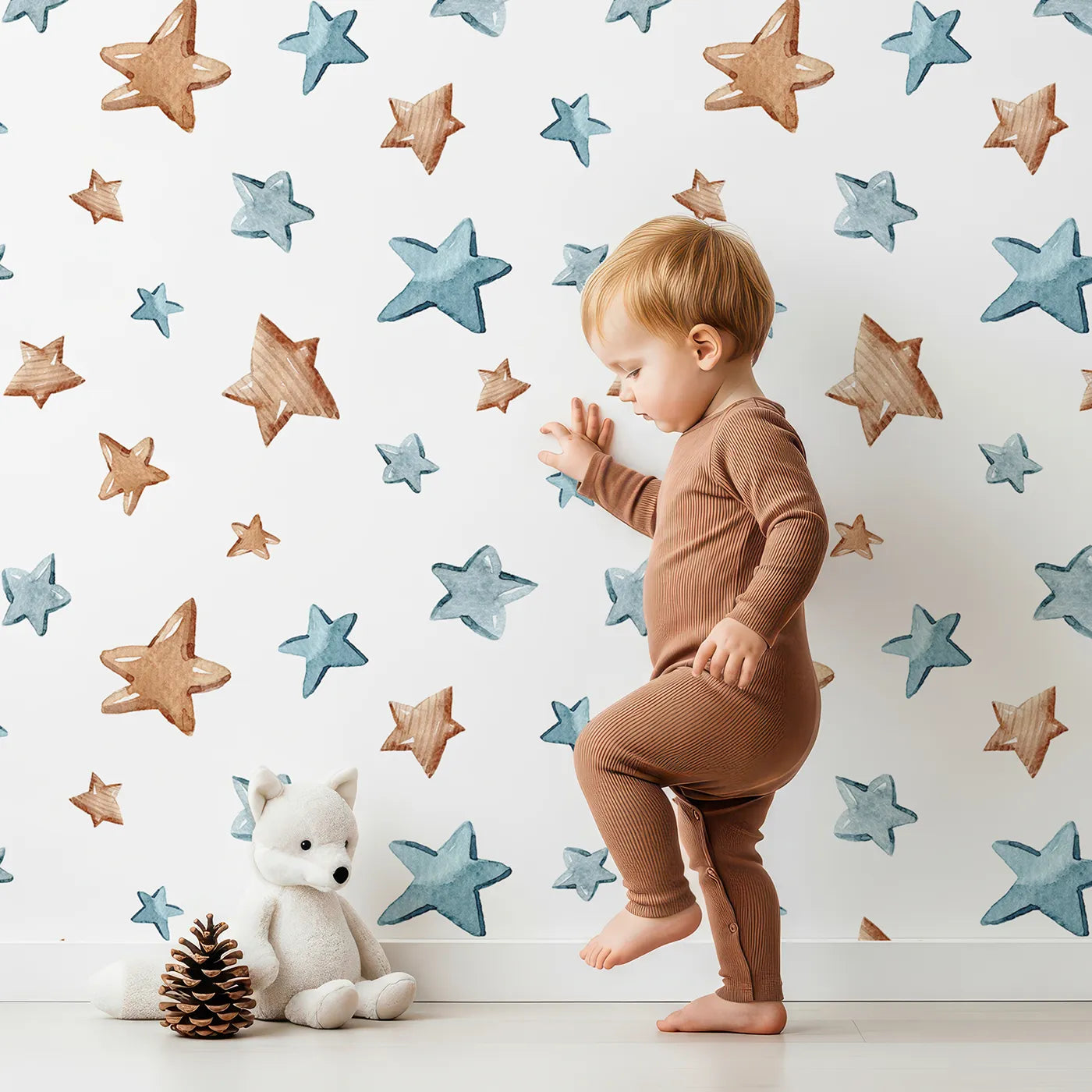Lovely child standing in front of Whimsy Tots Starry Drift Wallpaper in White with star, watercolor, sky, night in design.