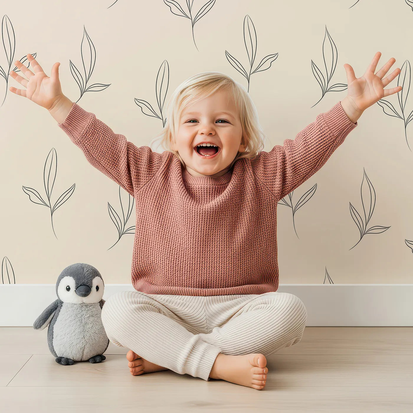 Lovely child standing in front of Whimsy Tots Line Art Leaflet in Sand with leaf, sprig, branch in design.