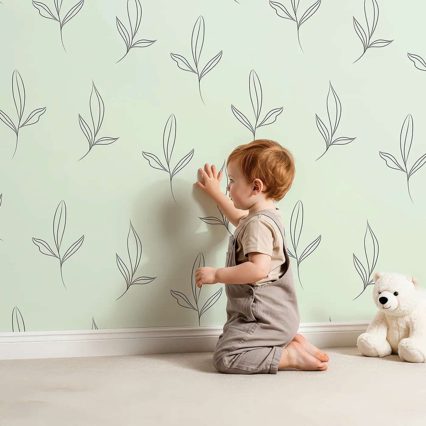 Lovely child standing in front of Whimsy Tots Line Art Leaflet in Mint Green with leaf, sprig, branch in design.
