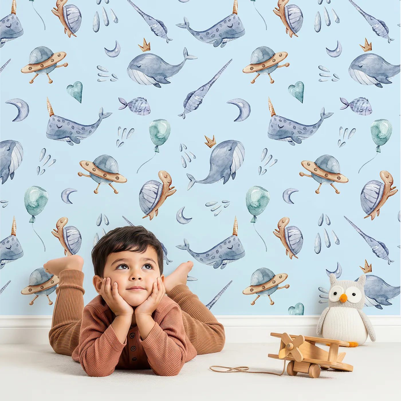 Lovely child standing in front of Whimsy Tots Ocean Galaxy Friends in Sky with whale, turtle, ufo, balloon, moon, fish, splash, star, narwhal in design.