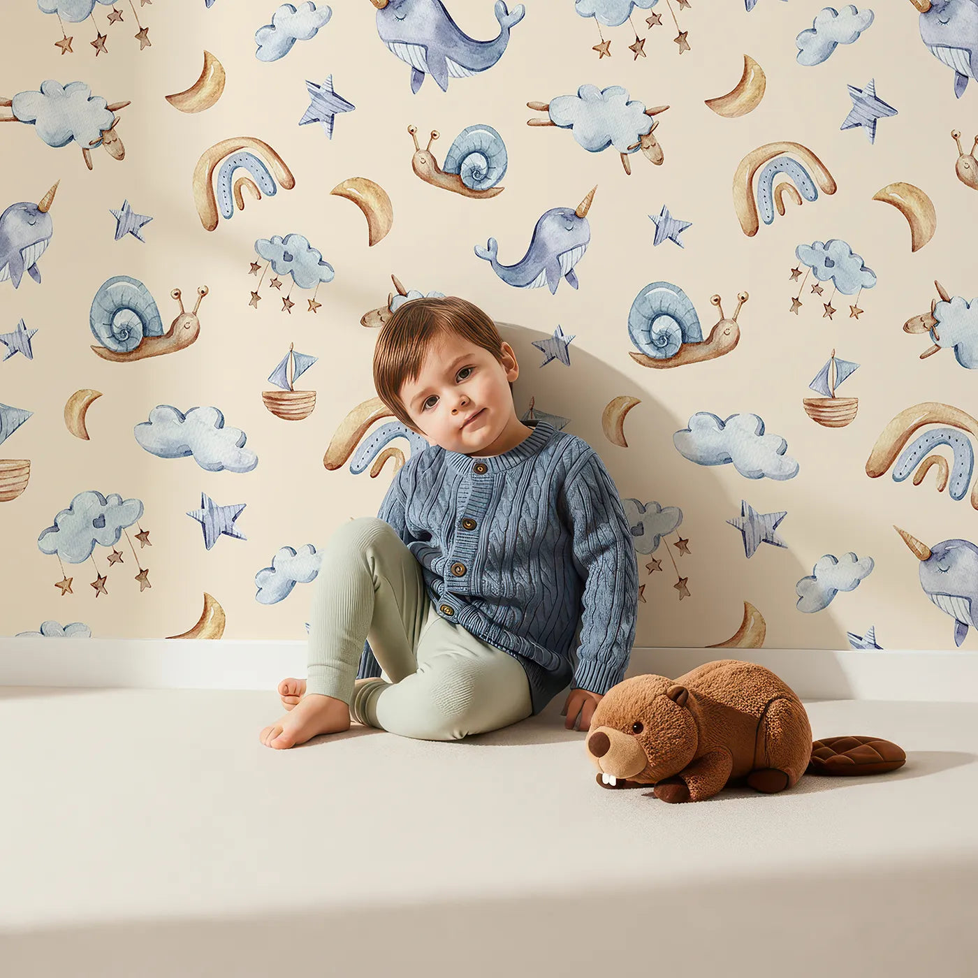 Lovely child standing in front of Whimsy Tots Sleepy Sky Parade in Beige with sheep, snail, narwhal, whale, cloud, star, moon, rainbow, sailboat in design.