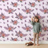 Lovely child standing in front of Whimsy Tots Berry Meadow Whispers in Blush Pink with flower, petal, leaf, sprig in design. Lovely child standing in front of Whimsy Tots Berry Meadow Whispers in Blush Pink with flower, petal, leaf, sprig in design.
