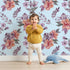 Lovely child standing in front of Whimsy Tots Blushing Garden Harmony in Sky with flower, petal, leaf, sprig in design. Lovely child standing in front of Whimsy Tots Blushing Garden Harmony in Sky with flower, petal, leaf, sprig in design.