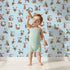 Lovely child standing in front of Whimsy Tots Rustic Alphabet Adventure in Sky with letter, alphabet, tree, boat, plant in design. Lovely child standing in front of Whimsy Tots Rustic Alphabet Adventure in Sky with letter, alphabet, tree, boat, plant in design.