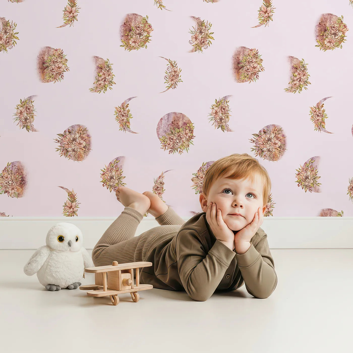 Lovely child standing in front of Whimsy Tots Moonlit Floral Whispers in Blush Pink with moon, flower, blossom, petal in design.