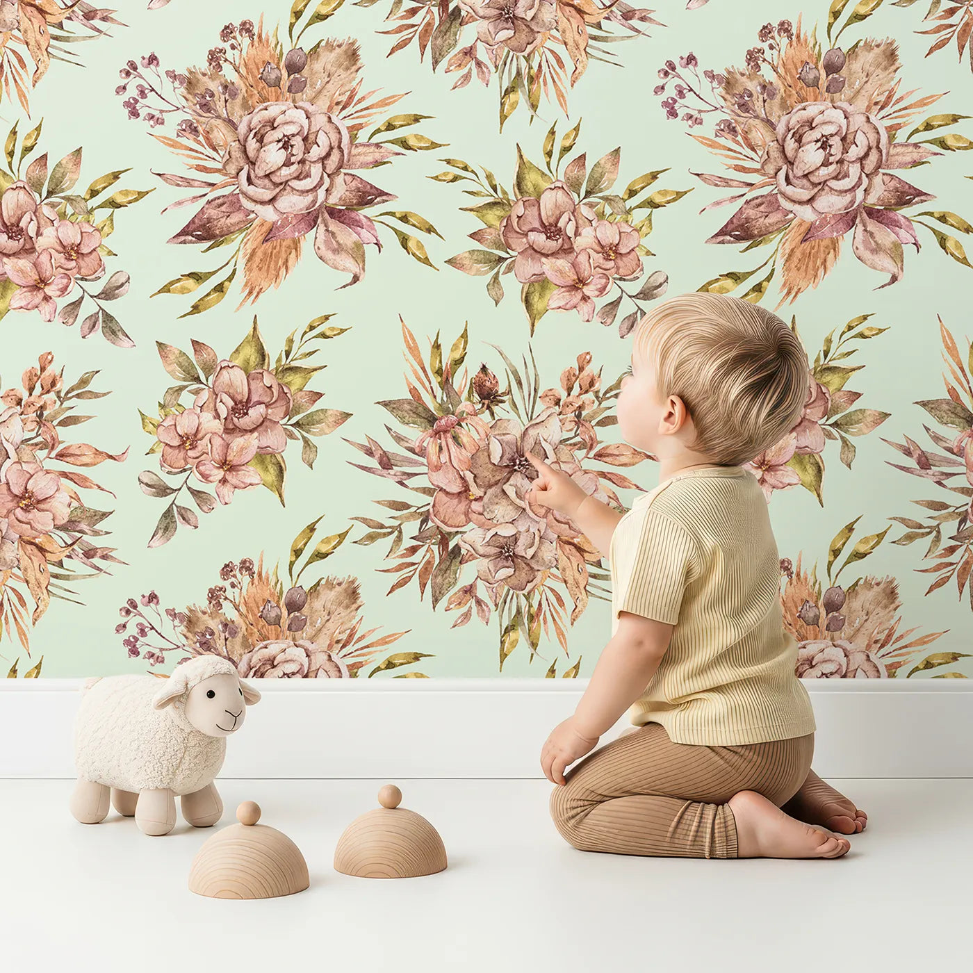 Lovely child standing in front of Whimsy Tots Autumn Bloom Harmony Wallpaper in Mint Green with flower, bouquet, rose, peony in design.