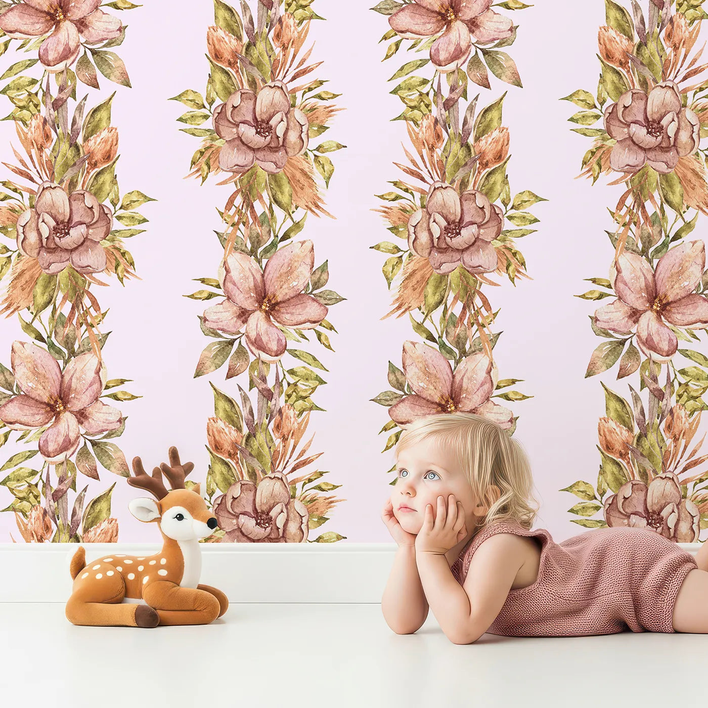 Lovely child standing in front of Whimsy Tots Vintage Garden Climb Wallpaper in Blush Pink with flower, vine, leaf, bouquet in design.