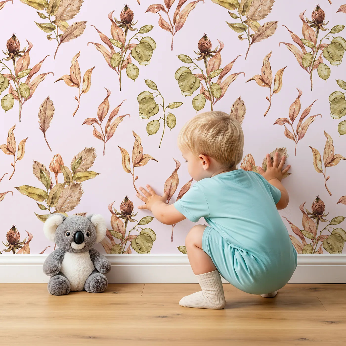 Lovely child standing in front of Whimsy Tots Autumn Forage Garden Wallpaper in Blush Pink with leaf, pod, sprig, branch in design.