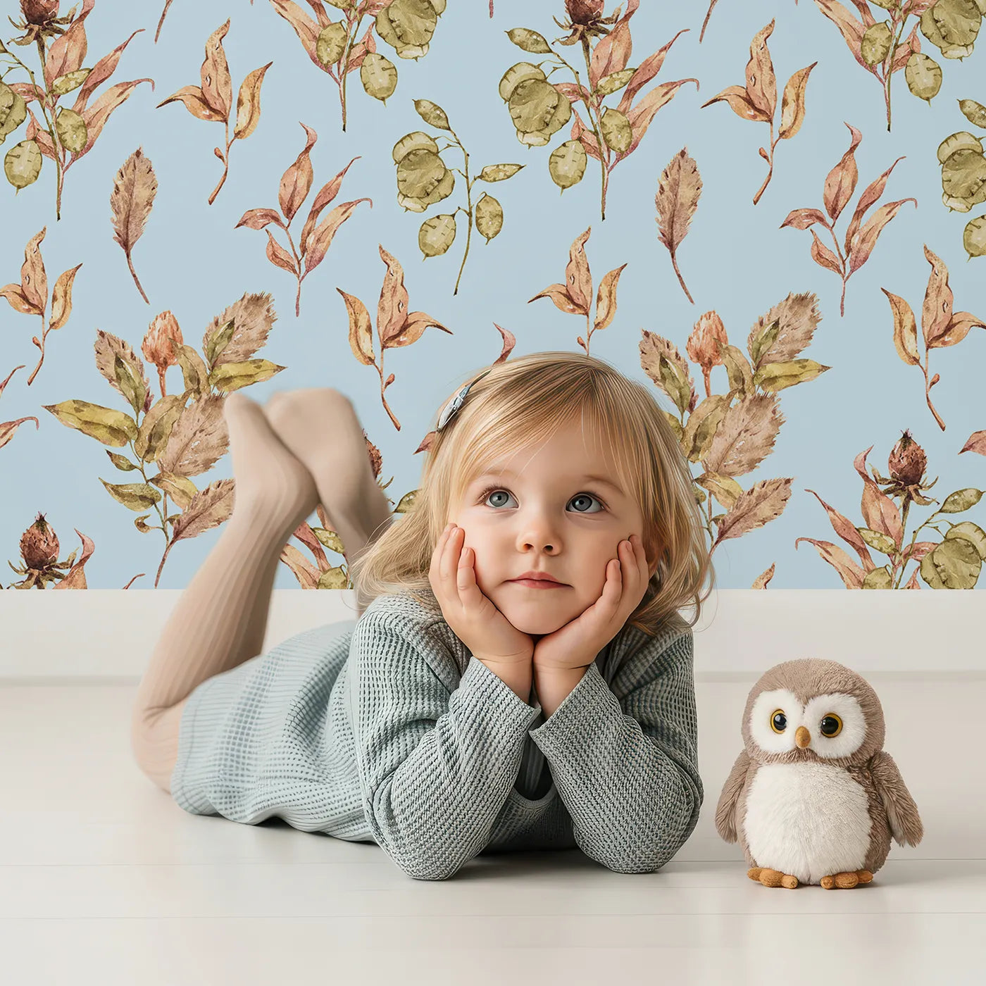 Lovely child standing in front of Whimsy Tots Autumn Forage Garden Wallpaper in Sky with leaf, pod, sprig, branch in design.