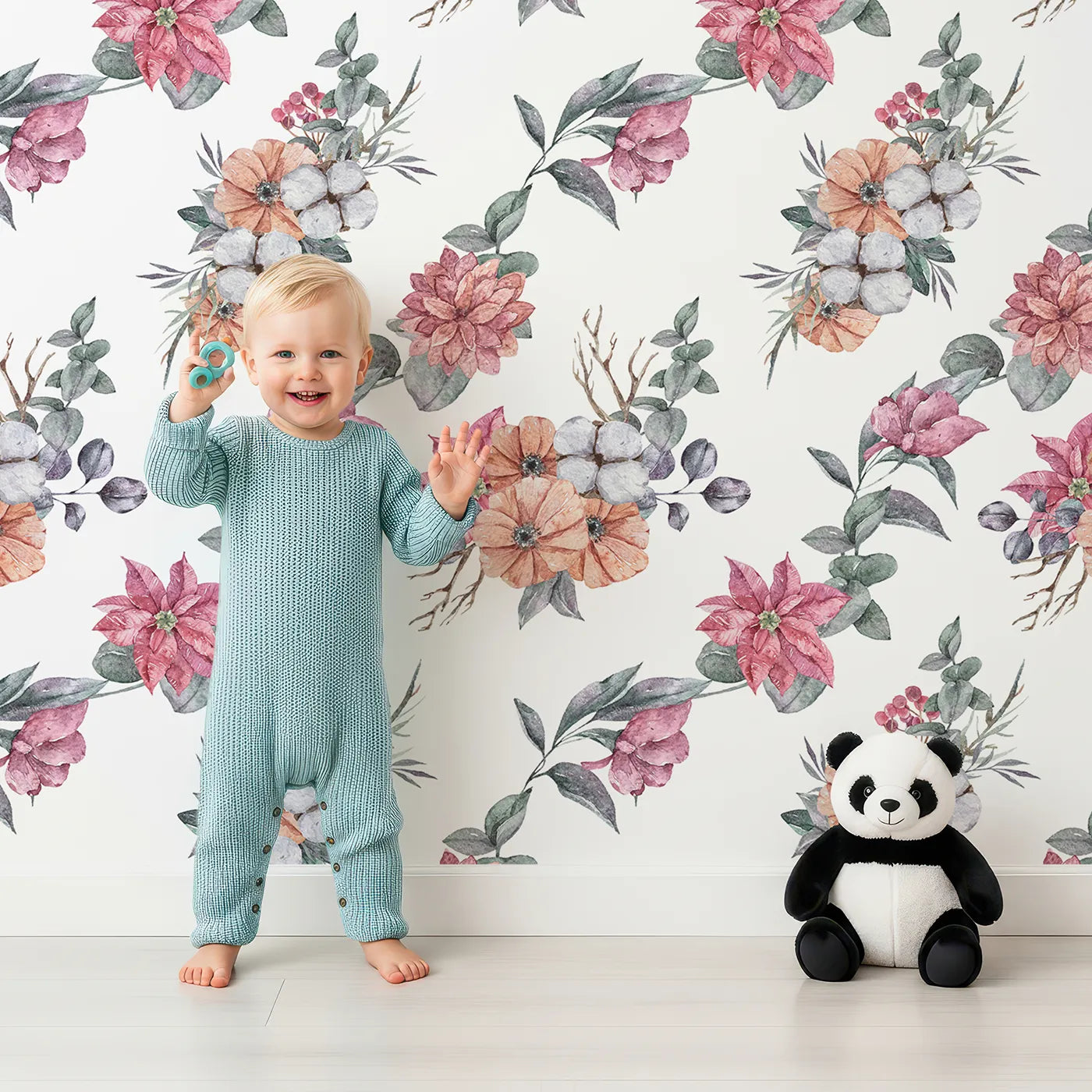 Lovely child standing in front of Whimsy Tots Winter Blooming Garden Wallpaper in White with flower, cotton, eucalyptus, poinsettia in design.